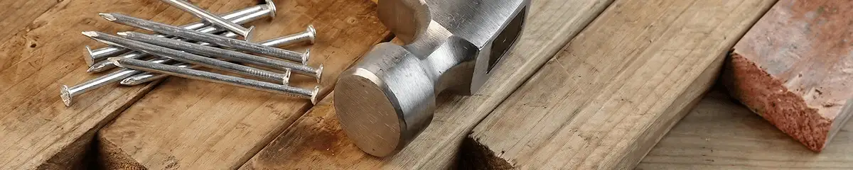 Hammer and nails on hardwood flooring boards in Marietta, GA