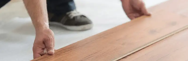 A professional installing laminate flooring in Marietta, GA
